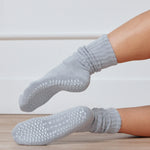 Women wearing a light blue mid-weight knit grip sock that scrunches, made for Pilates, Barre, Yoga, and Beyond. 