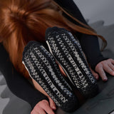 Women on a yoga mat wearing a black and grey stripped full foot pilates grip sock, made for pilates, barre, yoga, and beyond.