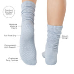 Women wearing a light blue mid-weight knit grip sock that scrunches, made for Pilates, Barre, Yoga, and Beyond and a list of product features.