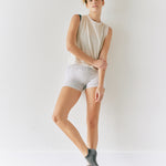 Women wearing a solid gray full foot grip sock made for Pilates, Barre, Yoga, and beyond. 