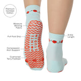 Woman wearing a solid light blue ankle grip sock with red tomatos on garden vines. Made for pilates, yoga, barre, and beyond. With a list of product features.