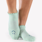 Women wearing baby blue grip socks with blue face for Pilates, Barre, Yoga, and beyond. 