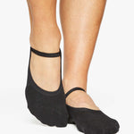 Woman wearing a black dance style strap grip cocktail, made for pilates, barre, yoga, and beyond. 